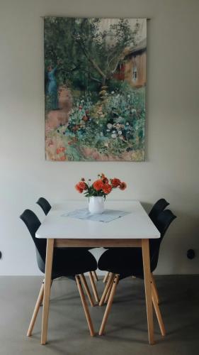 a table with a vase of flowers on top of it at Rural Cottage With Views Over Herrljunga in Ljung