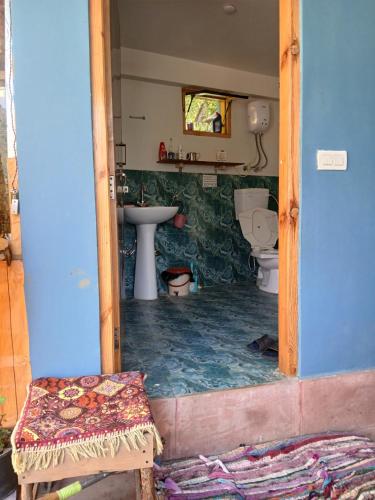 a bathroom with a sink and a toilet at Dormitory Hatago in Vashisht