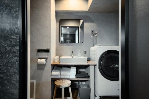 a bathroom with a sink and a washing machine at ulu Tokyo in Tokyo
