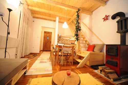 a living room with a fireplace and a table at Chalet Pahulja in Jahorina