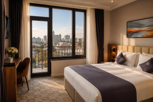a hotel room with a bed and a large window at Cosmopolitan Hotel in Shymkent