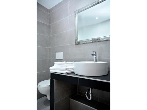 a bathroom with a sink and a toilet at Hotel Atrium in Pardubice