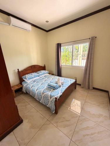 a bedroom with a bed and a window at Camotes Serenity in Camotes Islands