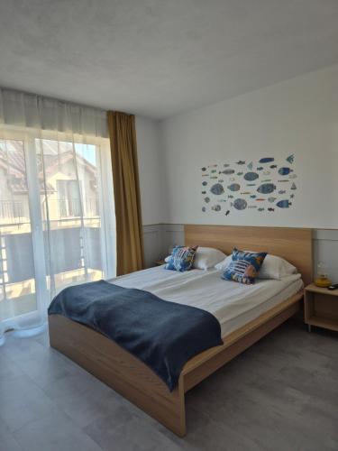 a bedroom with a bed and a large window at Willa Kardamon in Władysławowo