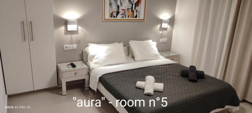 a bedroom with a bed with a cross on it at Papadioti Apartments in Pefki