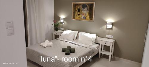 a small bedroom with a bed and a mirror at Papadioti Apartments in Pefki