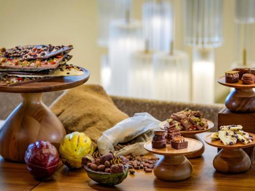 a table with different types of desserts on plates at Mövenpick Hotel Basel in Basel