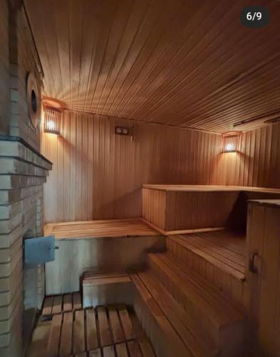 an empty wooden sauna with a bench in it at Delight Сая in Astana