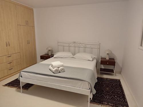 a bedroom with a bed with two towels on it at Diakofti Loft - Sea Breeze in Kythira