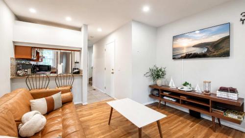 a living room with a couch and a table at Hampton Bays Townhouse - Pool Beach Access in Hampton Bays