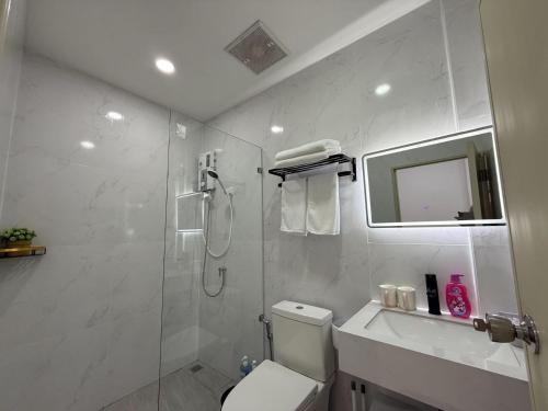 a white bathroom with a shower and a toilet at S hostel 302 sukhumvit48 near Phrakanong BTS in Amphoe Phra Khanong