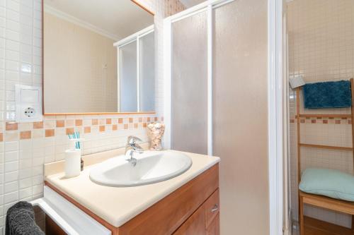 a bathroom with a sink and a shower at Can Tomeu in Calas de Mallorca