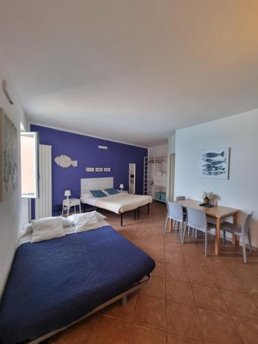a bedroom with a bed and a table and chairs at Vibes 5terre in Riomaggiore