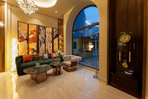 a living room with a couch and a clock at NiK Hotel Hillside Da Lat in Da Lat