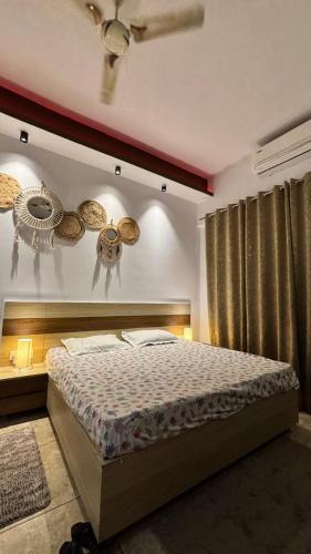 a bedroom with a bed and a ceiling fan at Golden Nest Stays in Ghaziabad