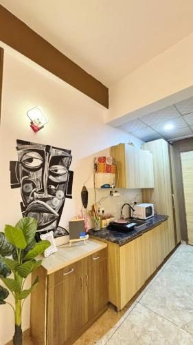 a kitchen with wooden cabinets and a counter top at Golden Nest Stays in Ghaziabad