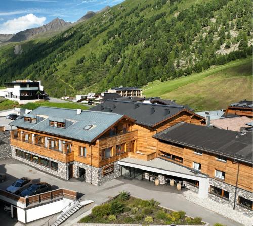 an aerial view of a large wooden building with a mountain at The Moss - Your unique hideaway in Obergurgl