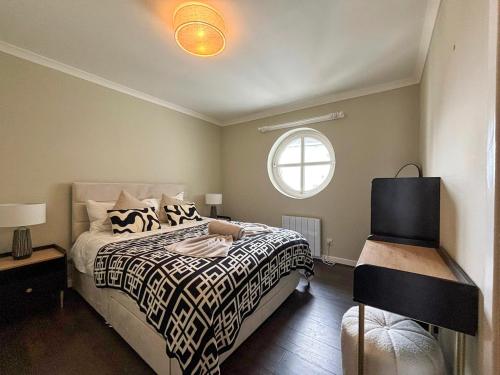 a bedroom with a bed and a window at Seaside Penthouse 1 in Largs