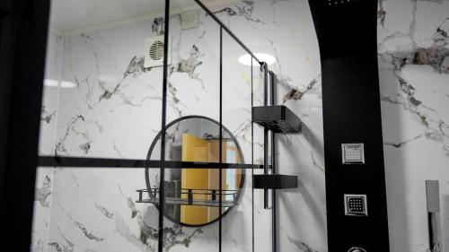 a bathroom with a glass shower with a mirror at Seaside Penthouse 1 in Largs