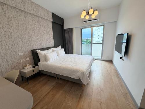 a bedroom with a bed and a television in it at Go Chishang B&B in Chishang
