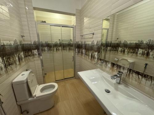 a bathroom with a toilet and a sink at Titanic Villa Kandy in Kandy