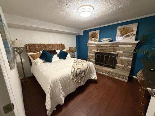 a blue bedroom with a bed and a fireplace at The Oasis in Clinton