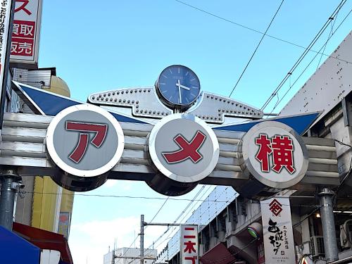 three signs with a plane on top of a building at Hotel New Ueno in Tokyo