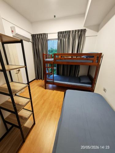 a room with two bunk beds and a ladder at JN Villa Homestay 5 Bedroom house, Near Airport Kota Kinabalu in Donggongon