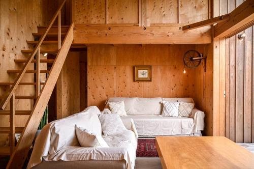 a living room with a couch and a staircase at anandahの宿 in Miyazaki