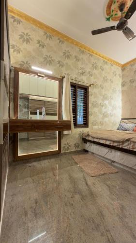 a room with a bed and a window in it at Yashaswi Hilldeck in Sondekoppa