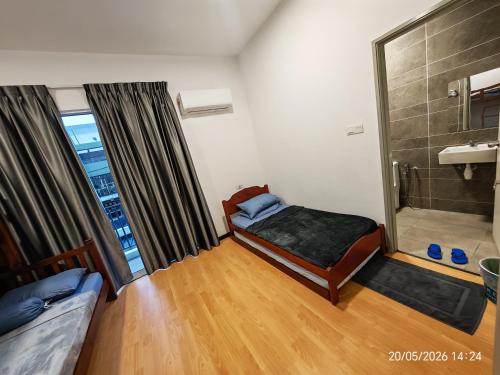 a small room with a bed and a shower at JN Villa Homestay 5 Bedroom house, Near Airport Kota Kinabalu in Donggongon