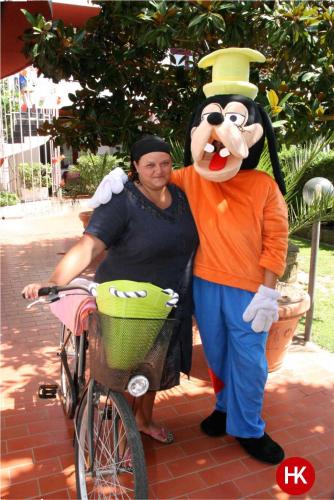 a woman is standing next to a man with a mickey mouse at Hotel Residence Key Club in Montalto di Castro