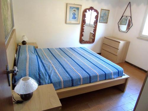 a bedroom with a bed and a mirror on the wall at Viletta Pioppi in Lido delle Nazioni