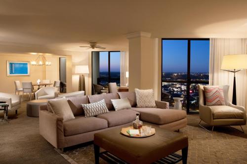a living room with a couch and a table at Hilton Orlando Buena Vista Palace - Disney Springs Area in Orlando
