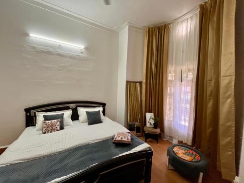 a bedroom with a large bed and a window at Himora in Gupta Kāshi
