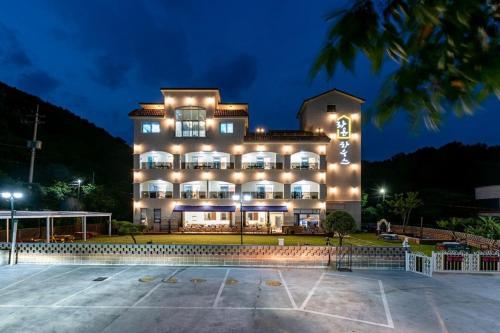 a large building with lights on it at night at Suncheon raon house egyeon pension in Suncheon