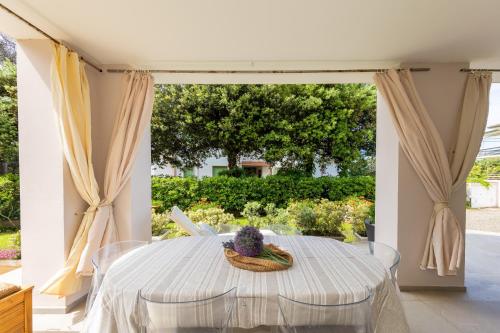 a dining room with a table and a window at Villa Atusca - Castiglioncello in Castiglioncello
