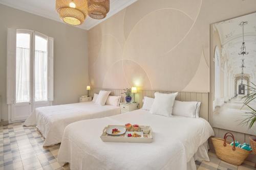 a room with two beds with a tray of food on it at Hostal Poblenou in Barcelona