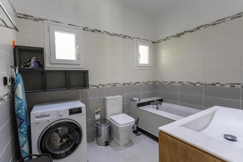 a bathroom with a washing machine and a washer at Mario's Kassiopi in Kassiopi