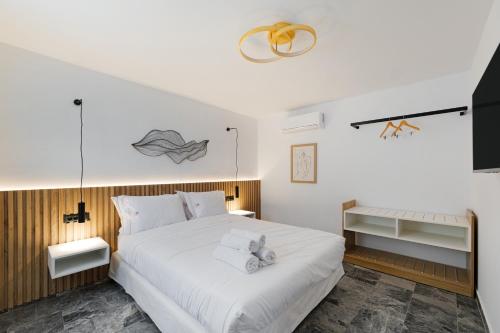 a bedroom with a white bed with a stuffed animal on it at Kismet Urban Boutique in Heraklio