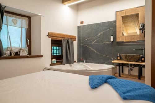 a bathroom with a bed and a tub and a sink at Rifugio del Firenze Ninfa in Sestola