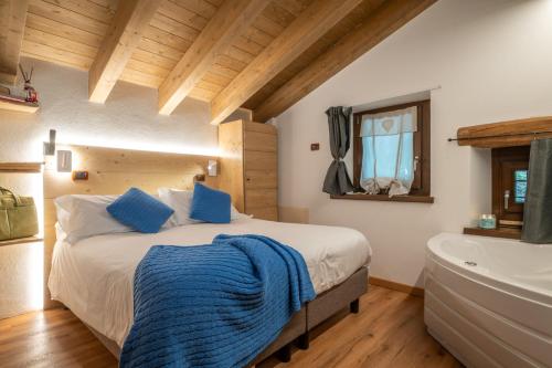 a bedroom with a large bed and a bath tub at Rifugio del Firenze Ninfa in Sestola
