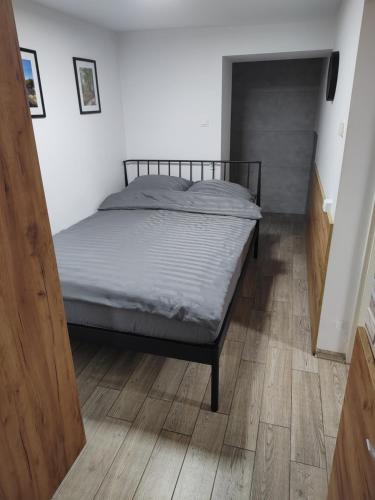 a bedroom with a bed and a wooden floor at Apartamenty Ustroń in Ustroń