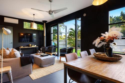 a living room with a couch and a table at Glenbrook Guest House in Ewingsdale