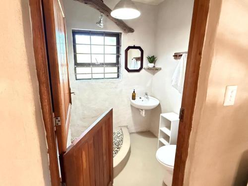 a small bathroom with a sink and a toilet at East River @ 21 in Kleinemonde