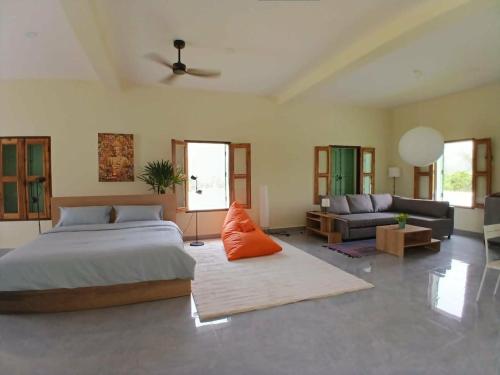 a bedroom with a bed and a living room at Half Way Villa in Luang Prabang