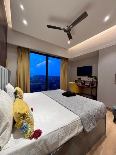 a bedroom with a large bed with a large window at Galaxy Blue Sapphire Studio in Ghaziabad