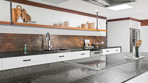 a kitchen with a sink and a counter at Glenbrook House and Studio in Ewingsdale