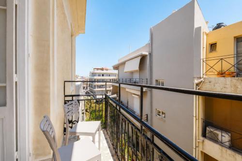 a balcony with chairs and a view of the city at Kismet Urban Boutique in Heraklio