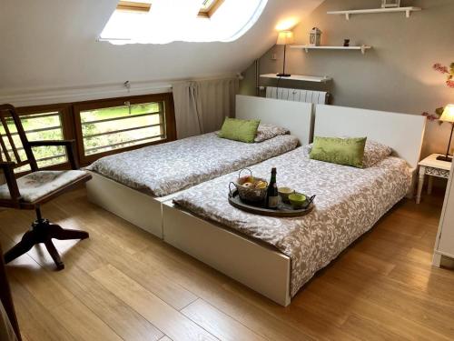 a bedroom with two beds with a tray of food on it at Gîte G4122 in Quincampoix